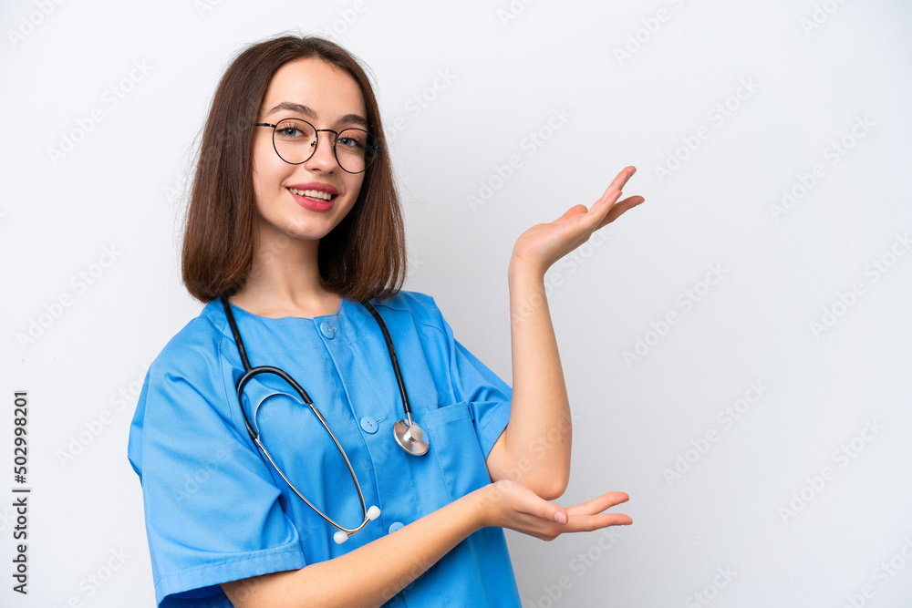 Young nurse Ukrainian woman isolated on white background extending hands to the side for inviting to come Young nurse Ukrainian woman isolated on white background extending hands to the side for inviting to come