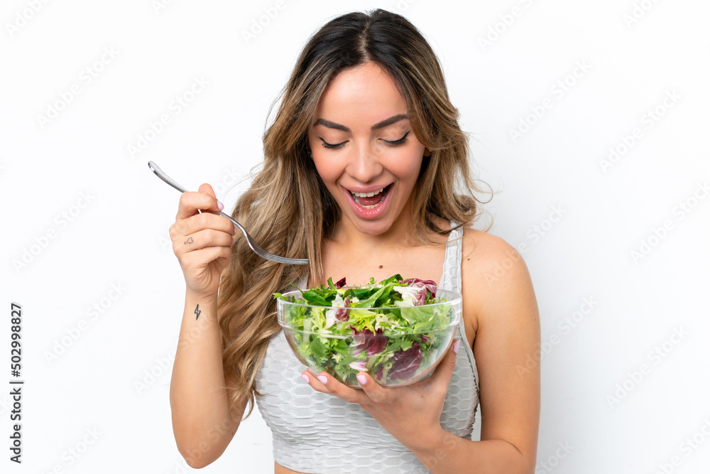 Young caucasian woman isolated on white background holding a bowl of salad with happy expression Young caucasian woman isolated on white background holding a bowl of salad with happy expression