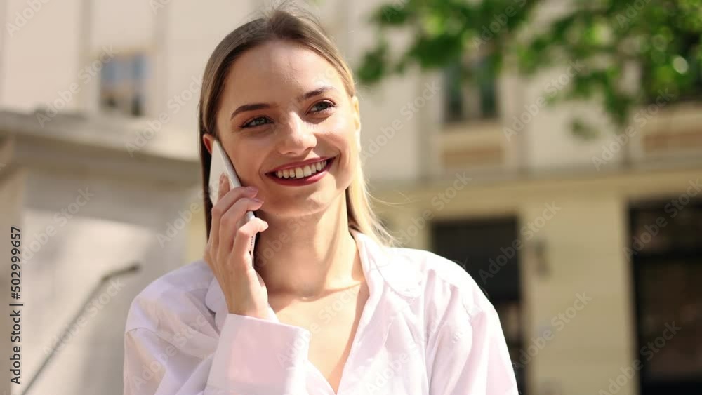 Portrait of attractive blond girl having phone talk. Young beautiful girl at the city street. Happy smiling girl walking forward. Portrait of attractive blond girl having phone talk. Young beautiful girl at the city street. Happy smiling girl walking forward.