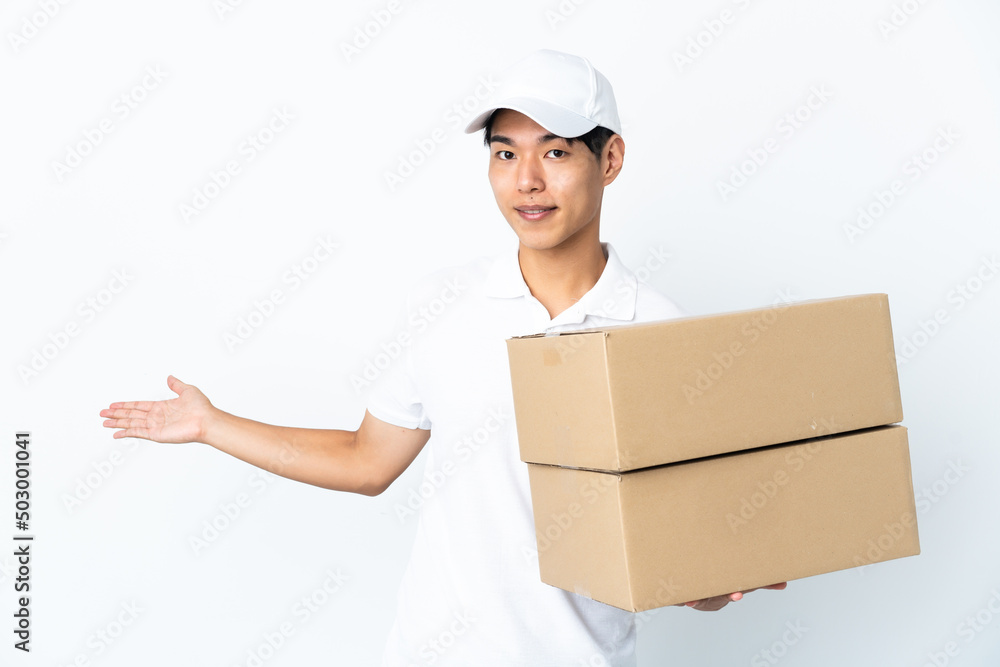 Delivery Chinese man isolated on white background extending hands to the side for inviting to come Delivery Chinese man isolated on white background extending hands to the side for inviting to come