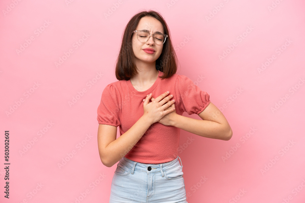 Young Ukrainian woman isolated on pink background having a pain in the heart Young Ukrainian woman isolated on pink background having a pain in the heart