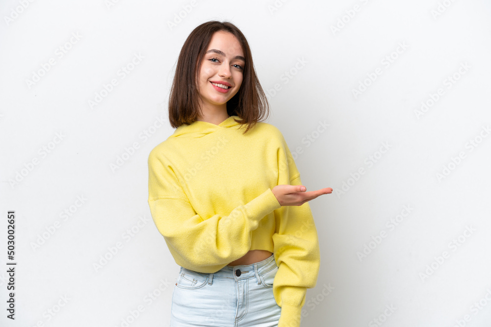 Young Ukrainian woman isolated on white background presenting an idea while looking smiling towards Young Ukrainian woman isolated on white background presenting an idea while looking smiling towards