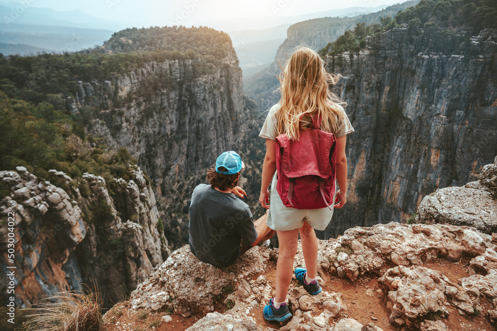 Couple hiking together travel hiking healthy lifestyle active summer vacations outdoor man and woman with backpack tourists on cliff Tazi canyon in Turkey - obrazy, fototapety, plakaty 