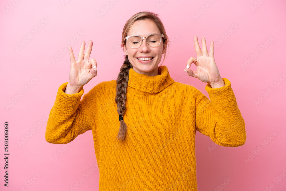 Young caucasian woman isolated on pink background in zen pose Young caucasian woman isolated on pink background in zen pose