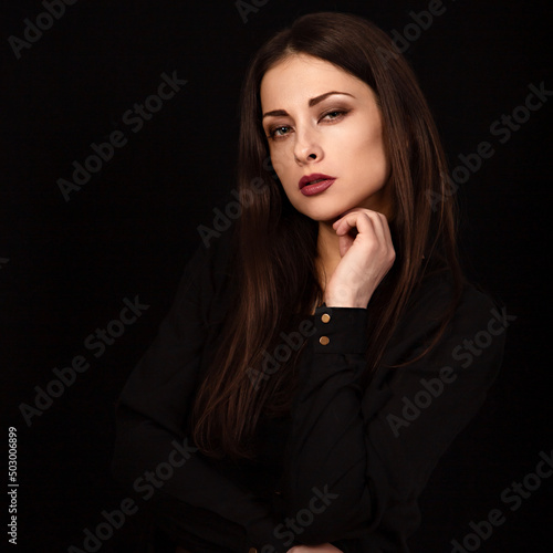 Beautiful confident happy smiling business woman with hand under the face on black background with empty copy space. Closeup portrait of natural happiness. © nastia1983