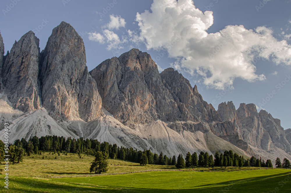 Sunny afternoon view of Puez-Odle mountain group knife-edge peaks as seen from Malga Glatsch refuge in Puez-Odle Nature park, Funes valley, Dolomites, Trentino Alto Adige, Bolzano, South Tyrol, Italy