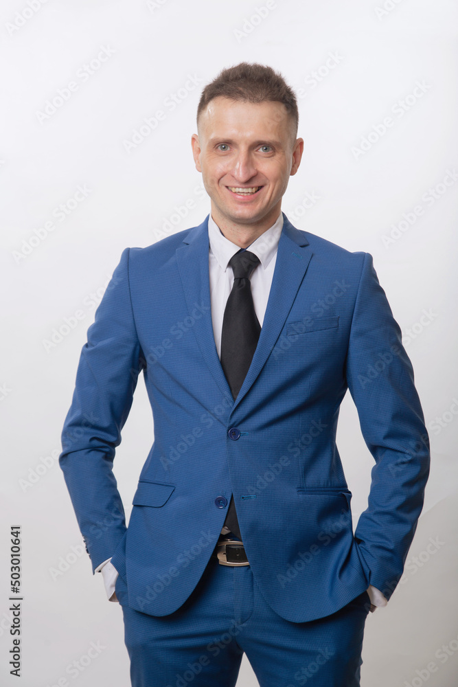 Fototapeta premium A satisfied man stands and smiles