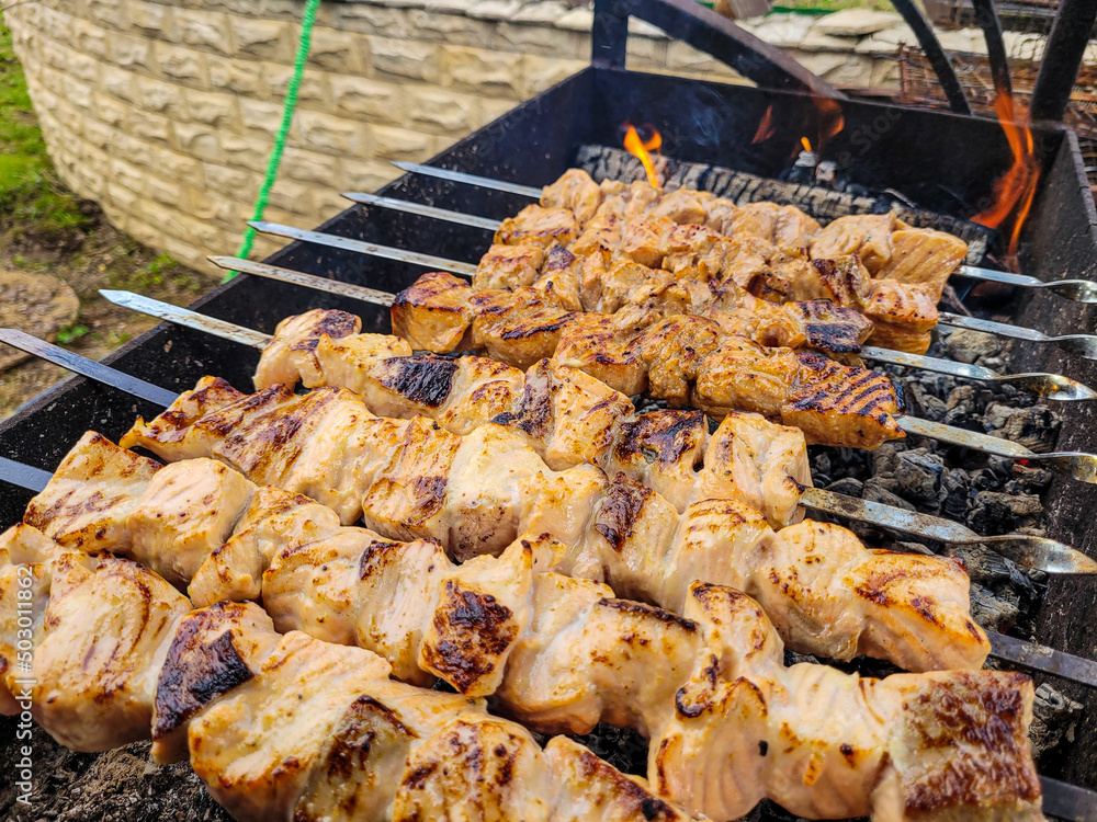 Grilled salmon fish kebab skewers on wooden board. Dark wooden background. Grilled salmon fish kebab skewers on wooden board. Dark wooden background.