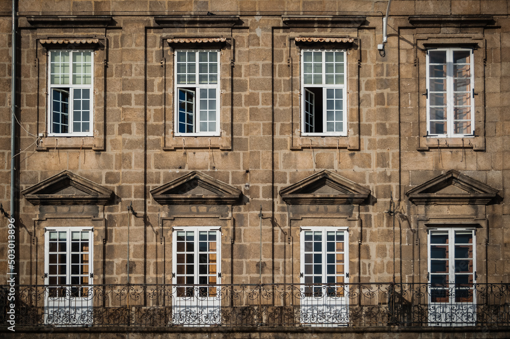 Facade with eight windows in old building, a coruña, Spain