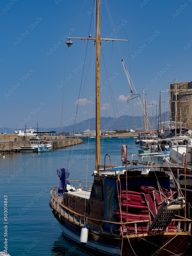boats in harbor with clear blue sky and sea
