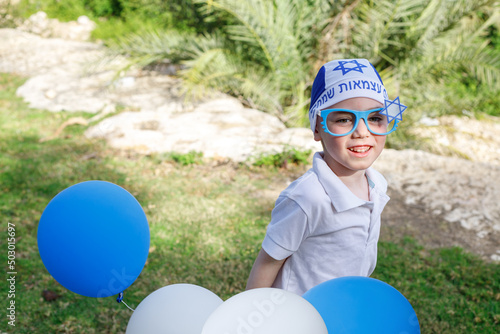 Little boy in a bandana and glasses with the symbols of Israel photo