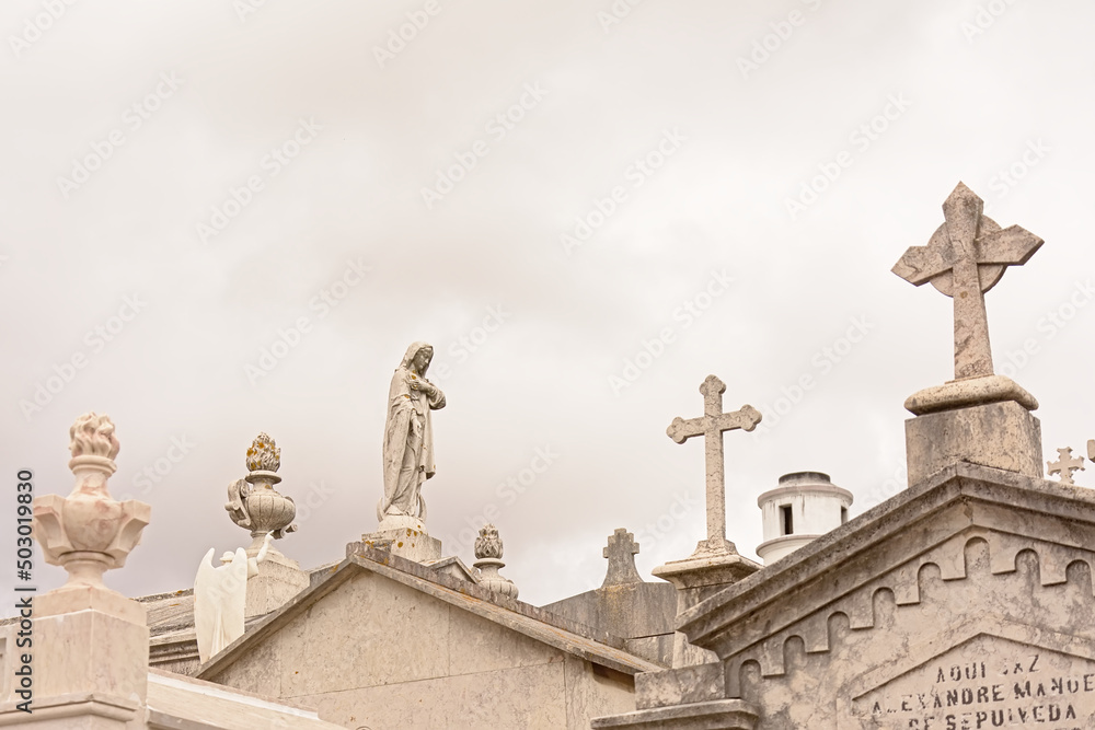  Statue of Virgin Mary and crosses on top of old grave tombs
Download preview
Statue of Virgin Mary and crosses on top of old grave tombs in Alto de Sao Joao cemetery, Lisbon, Portugal
