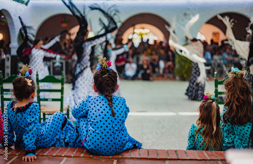Spanish womans dancing sevillanas in a traditional festival in Rota, Andalusia - Spain photo