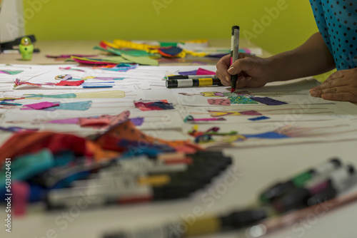 Close up of a fashion designer drawing new dress sketches