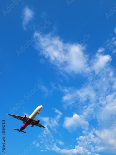 Airplane in the clouds. Blue sky