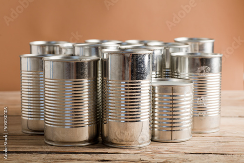 recycled cans, reused on a table with a brown background 