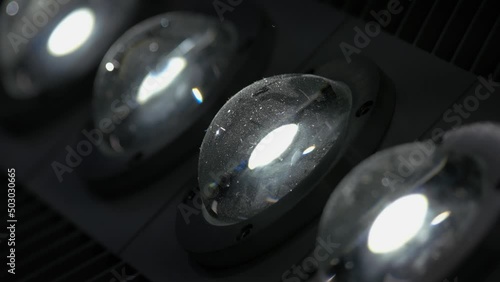 Close-up of turning on diode LED lights. Semisphere reflective glass lamps. photo