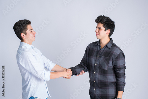 Expression of security, trust, and friendship: two people shaking hands. employment and business opportunity. share with a friend and agree.