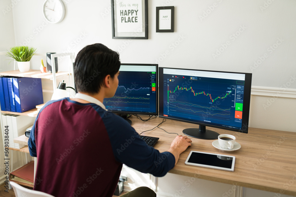 Rear view of a broker investing in stocks
