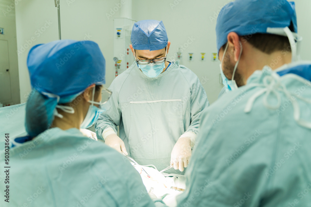 Rear view of three surgeons Rear view of three surgeons