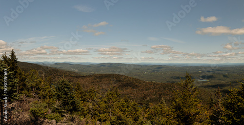 a panoramic view from the top of mount haystack in vermont showing forests, hills and mountains