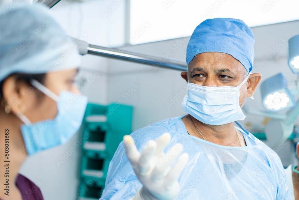 close up shot of surgeon busy operating surgery with support staff or practitioners at operation theater - concept of profesional occupation, healthcare treatment and emergency close up shot of surgeon busy operating surgery with support staff or practitioners at operation theater - concept of profesional occupation, healthcare treatment and emergency
