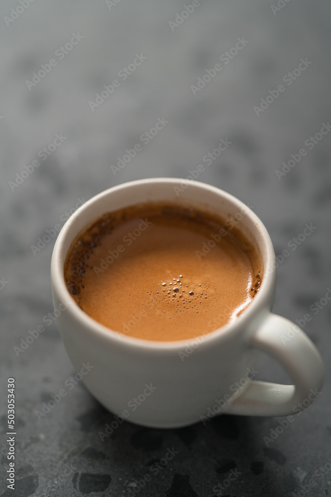 hot espresso in white cup on concrete background with copy space hot espresso in white cup on concrete background with copy space