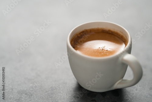 hot espresso in white cup on concrete background with copy space