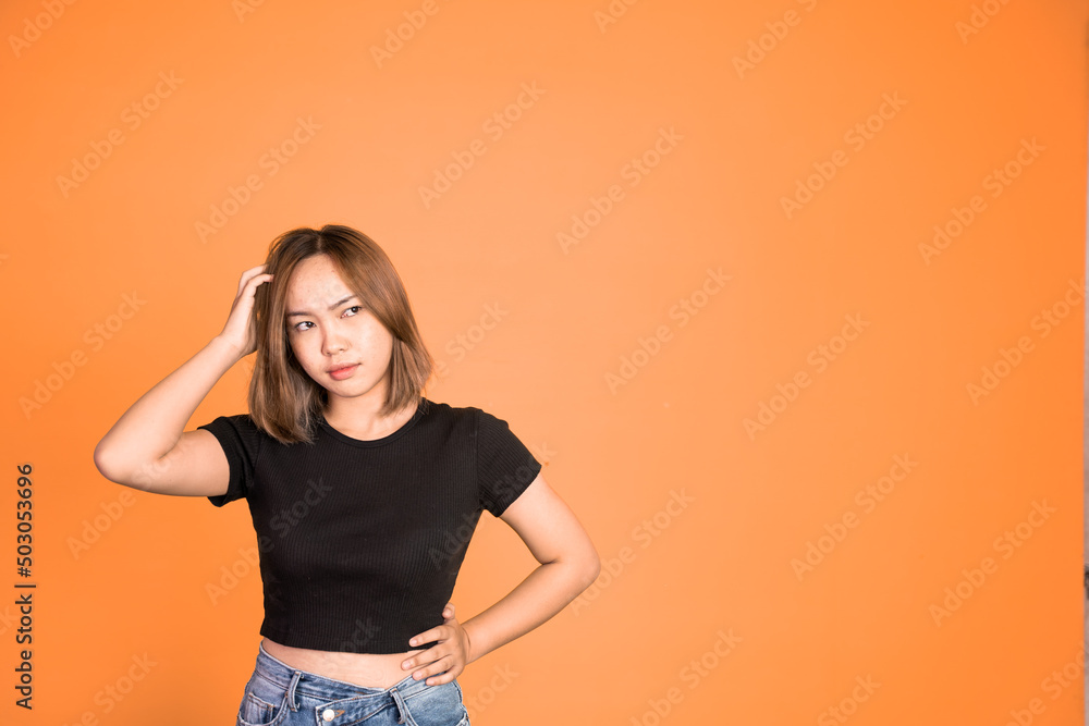 Thoughtful Asian woman poses against isolated background. girl looks confuse and thinking Thoughtful Asian woman poses against isolated background. girl looks confuse and thinking