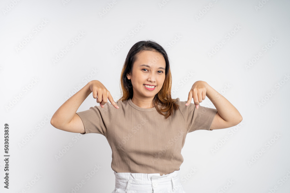 attractive asian woman with finger pointing down hand gesture on isolated background attractive asian woman with finger pointing down hand gesture on isolated background