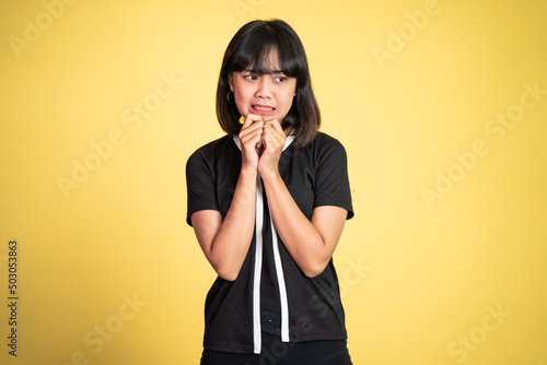 portrait of cynical asian woman expression while standing over isolated background photo