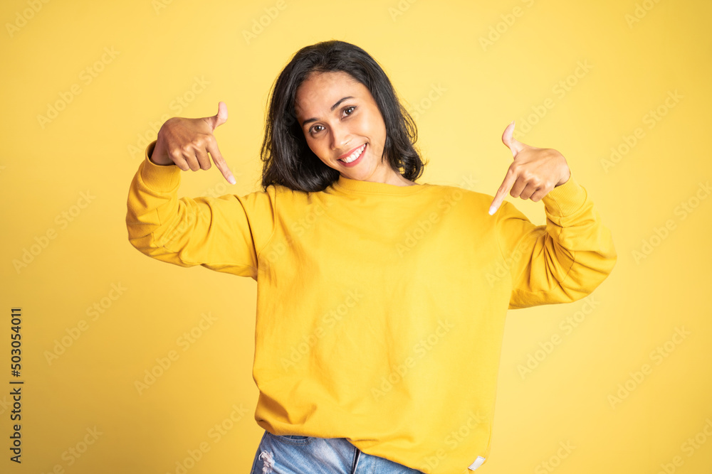 attractive asian woman with finger pointing down hand gesture on isolated background attractive asian woman with finger pointing down hand gesture on isolated background