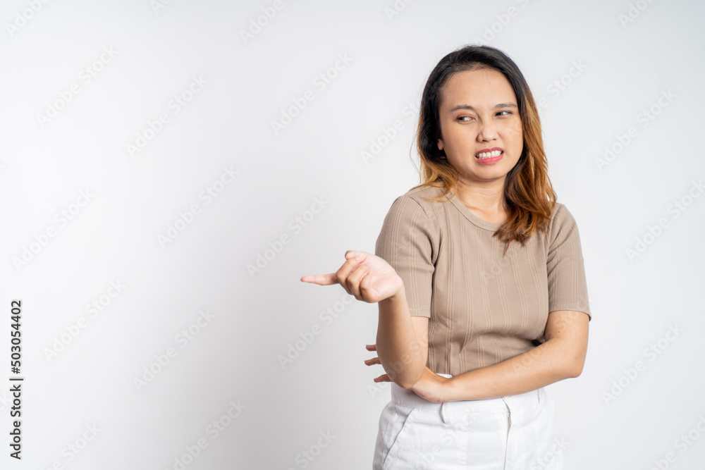 portrait of cynical asian woman expression while standing over isolated background portrait of cynical asian woman expression while standing over isolated background