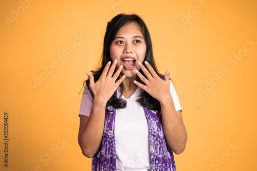 portrait of young asian woman feeling shocked and suprised over isolated background