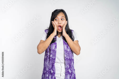 portrait of young asian woman feeling shocked and suprised over isolated background photo