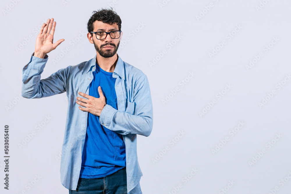 Man swearing honesty and devotion, Honest man raising his hand, a A guy raising his hand swearing, young man raising a hand promising something Man swearing honesty and devotion, Honest man raising his hand, a A guy raising his hand swearing, young man raising a hand promising something