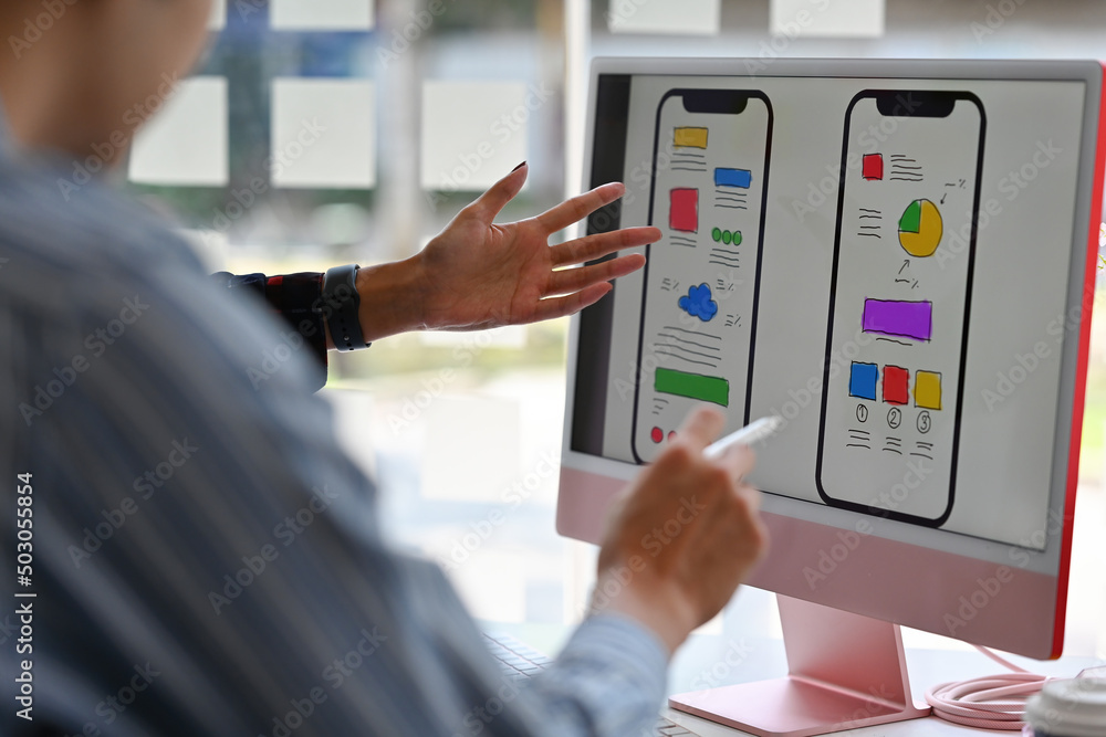 The close-up shoulder view with a layout of the media software development design on a computer desktop screen. Technology and design concepts. The close-up shoulder view with a layout of the media software development design on a computer desktop screen. Technology and design concepts.