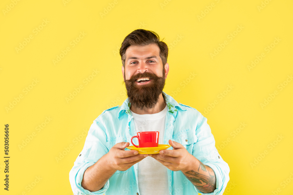 happy hipster with beard holding coffee cup on yellow background, coffee