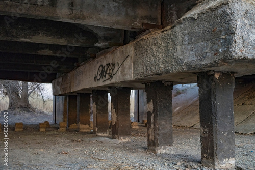 inscriptions on concrete under an abandoned bridge