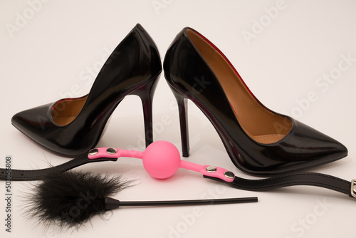 high heel fetish shoes feathered and ball gag fetish equipment isolated