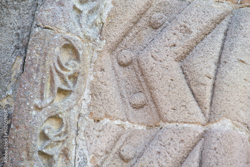 sandstone carvings in the entrance arch of a Romanesque style church. church of Santa Olaya de Selorio, Asturias, Spain. master stonemasons