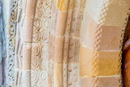 sandstone carvings in the entrance arch of a Romanesque style church. church of Santa Olaya de Selorio, Asturias, Spain. master stonemasons photo