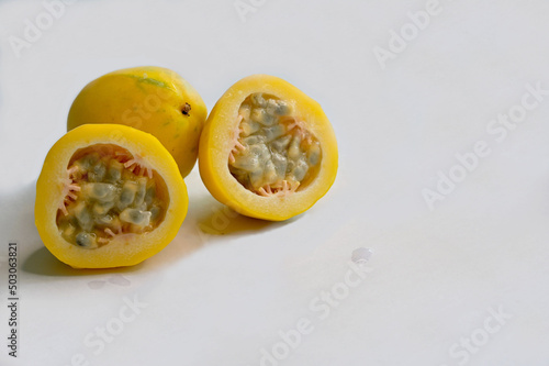 Yellow or golden passion fruit on white background photo