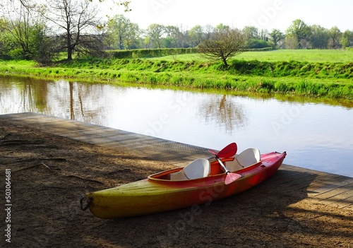 Kayak next to the Kleine Nete river. Boat on the side, at the Waterral in Herentals, Belgium.