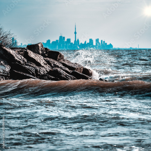 Photography Water hitting the rocks against the cityscape of Toronto. Canada.