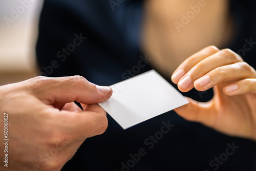 Person Hands Giving Visiting Card To Another Person