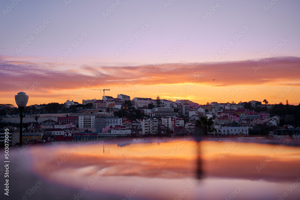 Beutiful view of old town in Lisbon. Red tiled roofs and sunset sky.