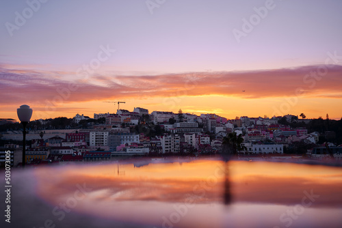 Beutiful view of old town in Lisbon. Red tiled roofs and sunset sky.