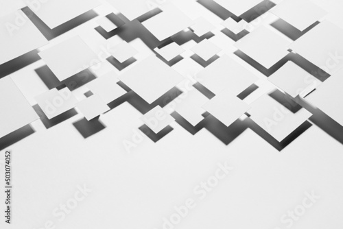 White geometric abstract background with rhombuses in hard light with strict gradient contrast dark shadows as border, copy space, top view. Simple contemporary backdrop in future style.