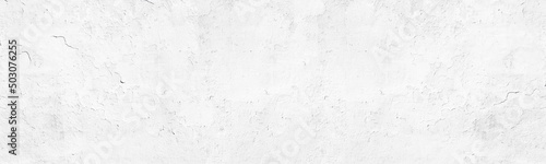 White painted old concrete wall wide panoramic texture. Grunge abstract whitewashed widescreen background
